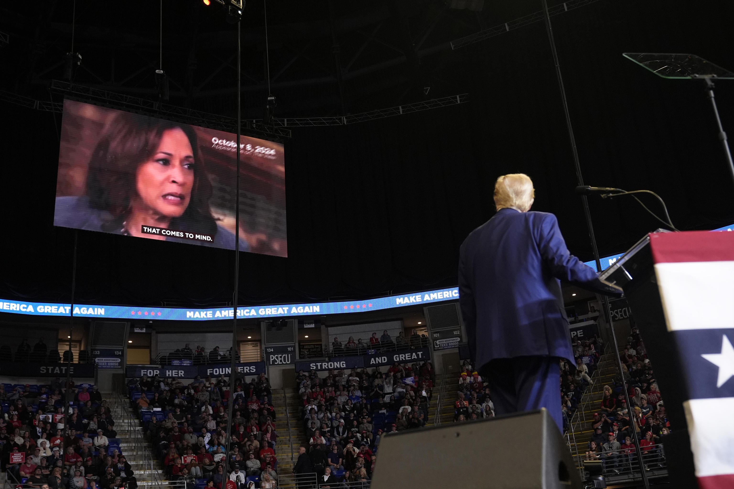 Trump watches a video of Kamala Harris during campaign rally.