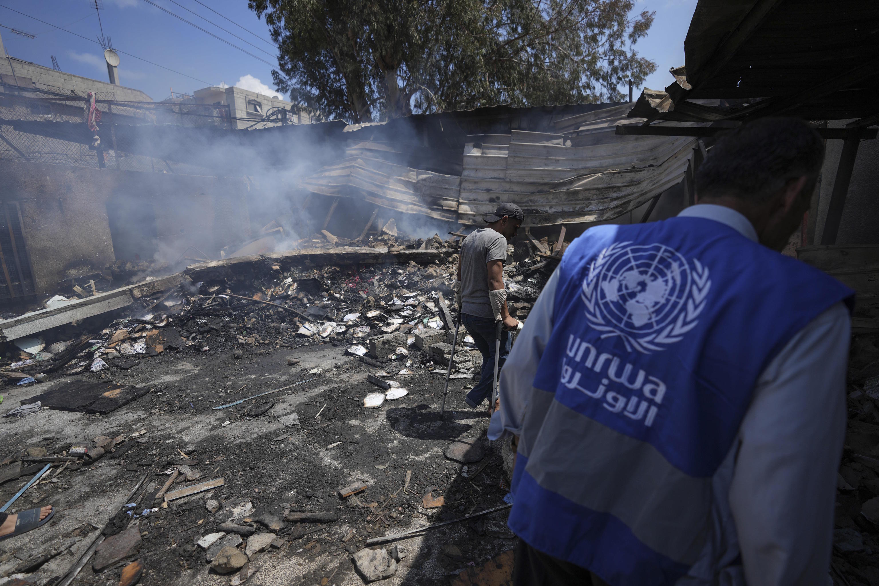 Palestinians look at the destruction after an Israeli strike on a school.