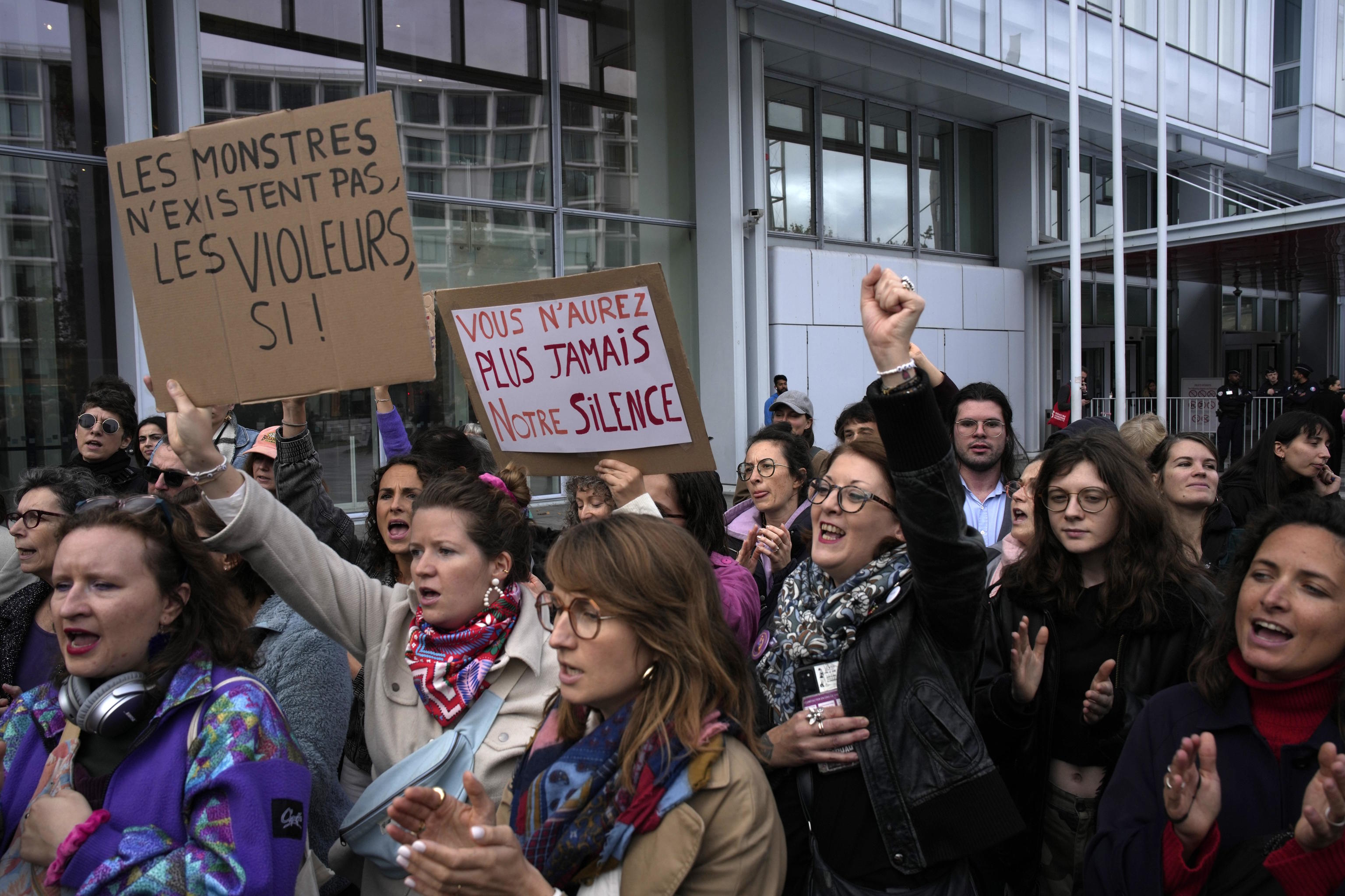 Women's rights activists demonstrate outside the Paris palace of justice.