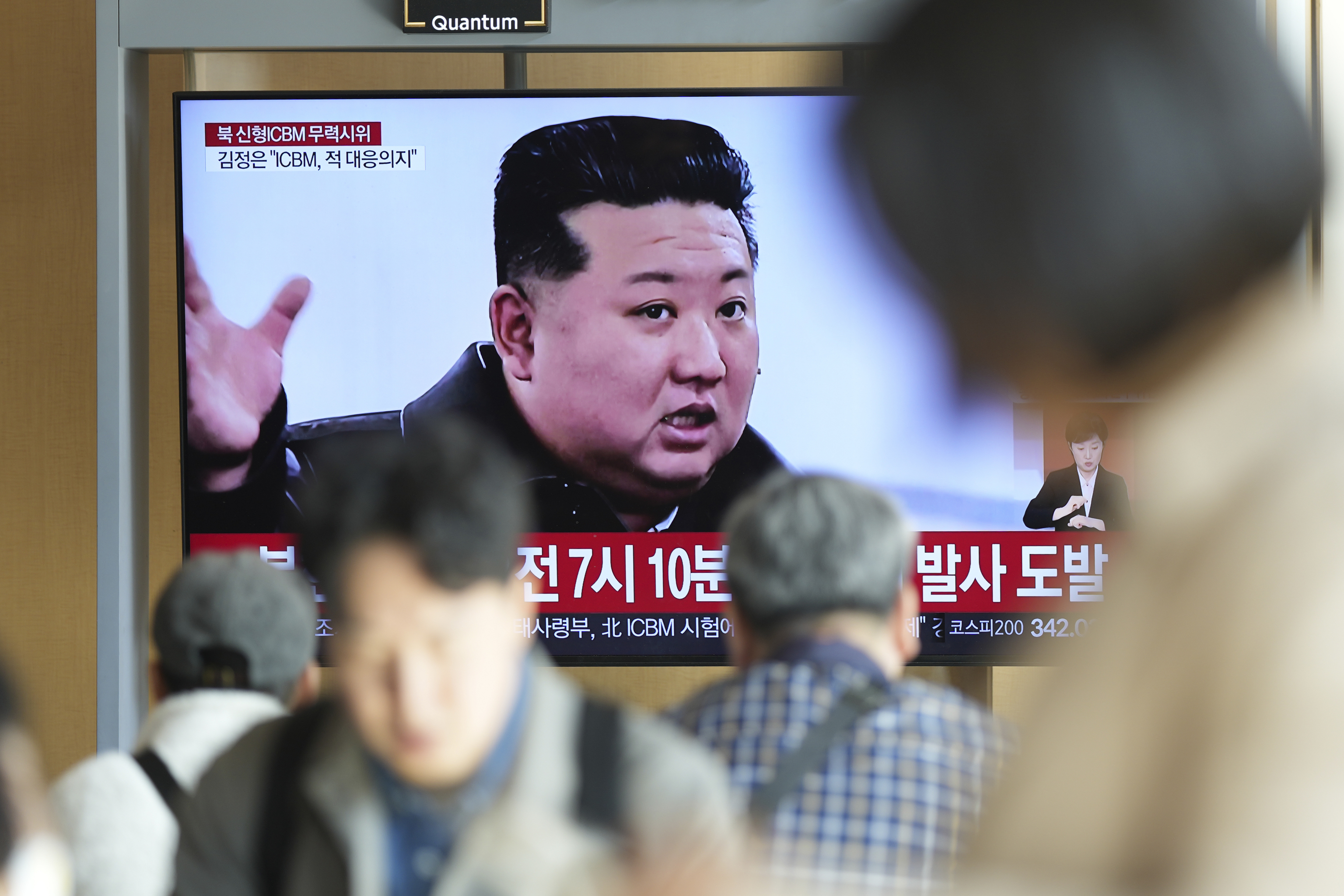 A TV screen shows an image of North Korean leader Kim Jong