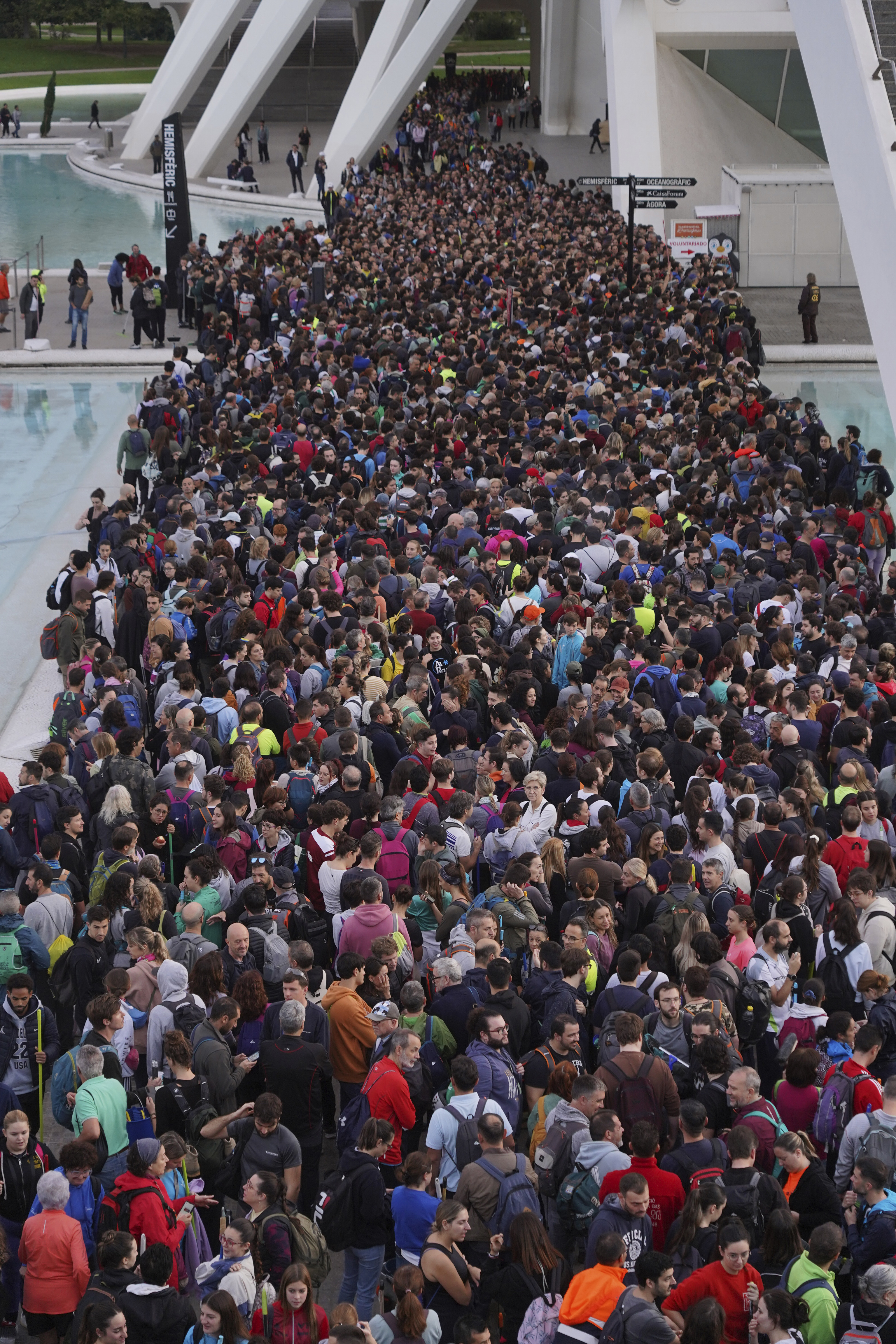 Thousands of volunteers show up at the City of Arts and Sciences cultural complex to be assigned work schedules to help with the clean up operation after floods in Valencia.