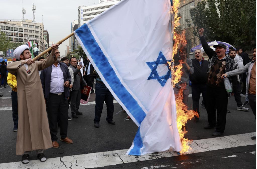 ranian demonstrators burn a representation of the Israeli flag in an annual rally in front of the former U.S. Embassy in Tehran,