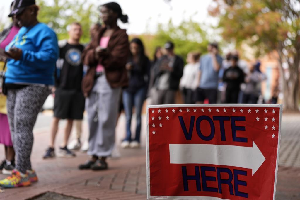 People stand in line during the last day of early voting