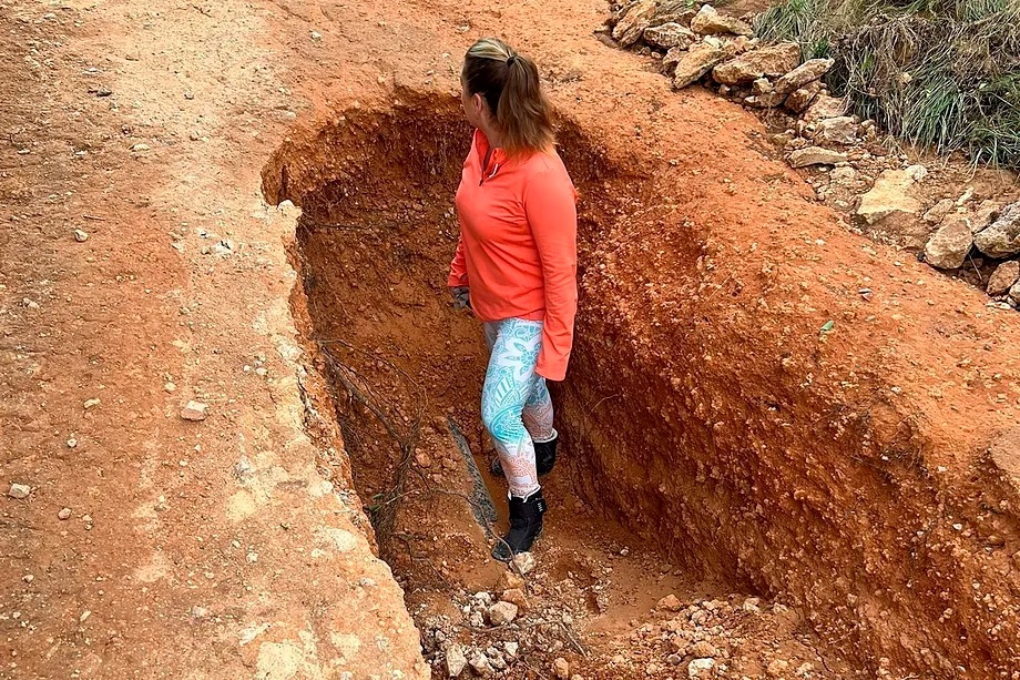 Carmina, inside a sinkhole on the access road to her house.