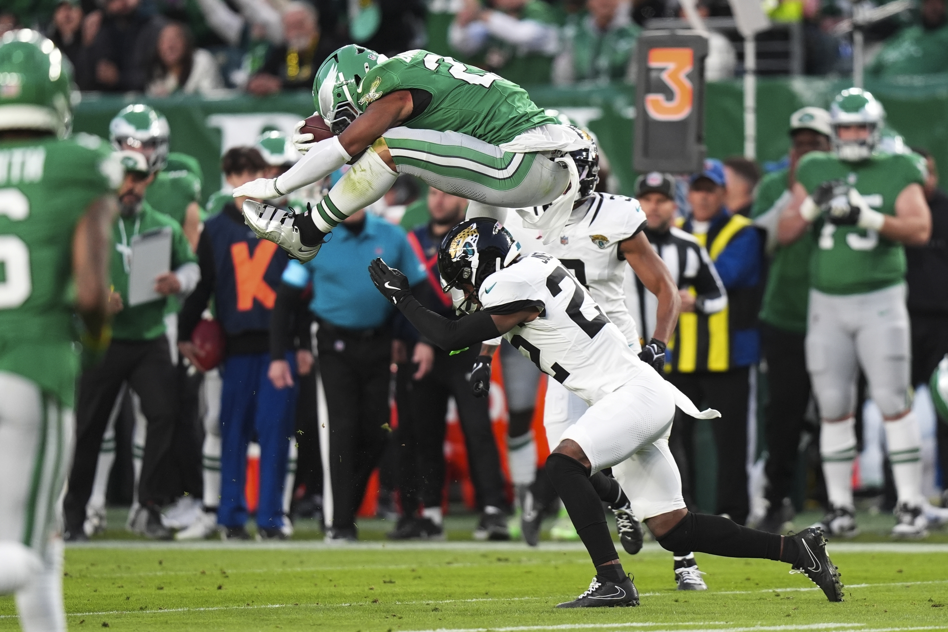 Philadelphia Eagles running back Saquon Barkley (26) hurdles over Jacksonville Jaguars cornerback Jarrian Jones (22).