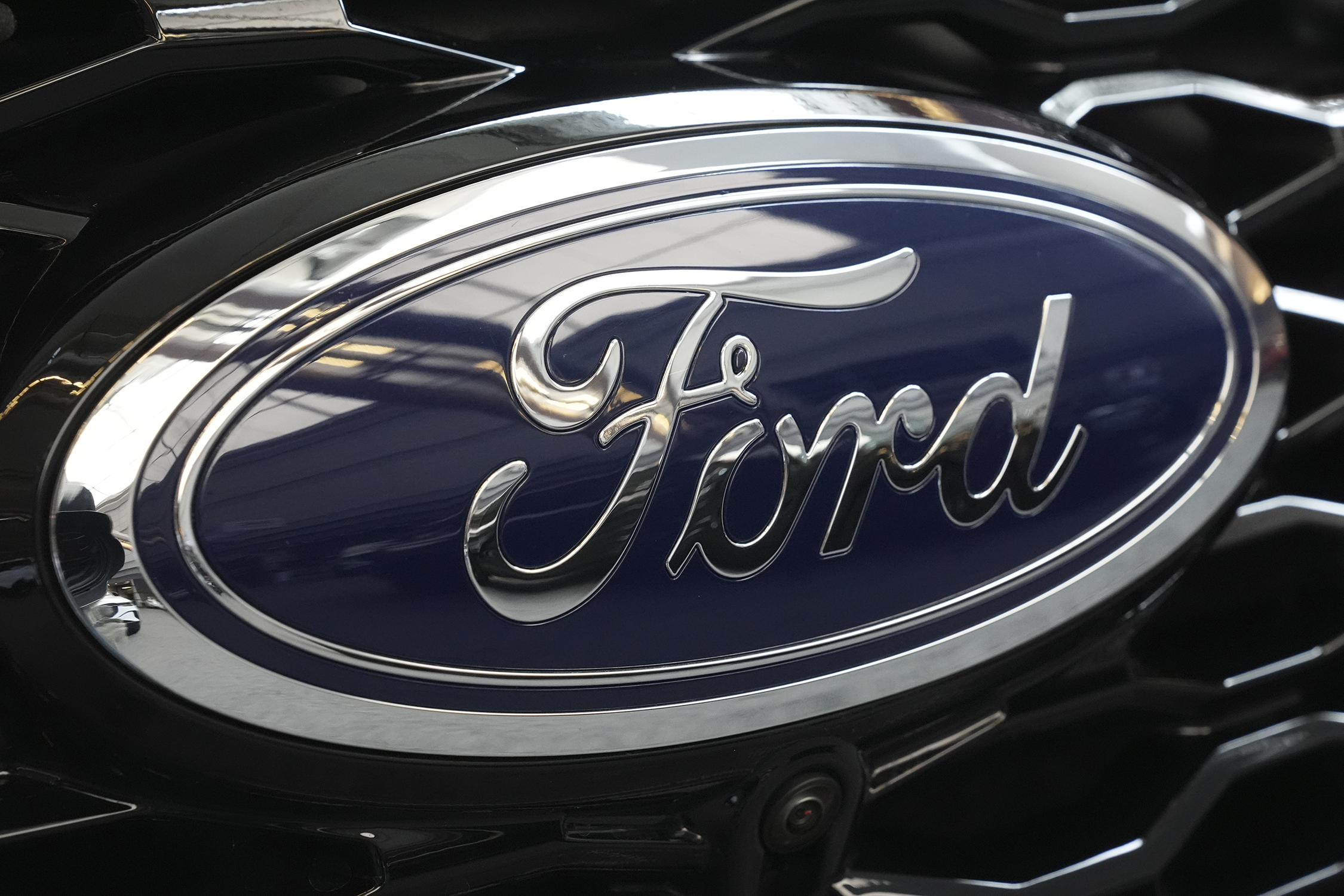 The Ford logo is seen on the grill of a Ford Explorer