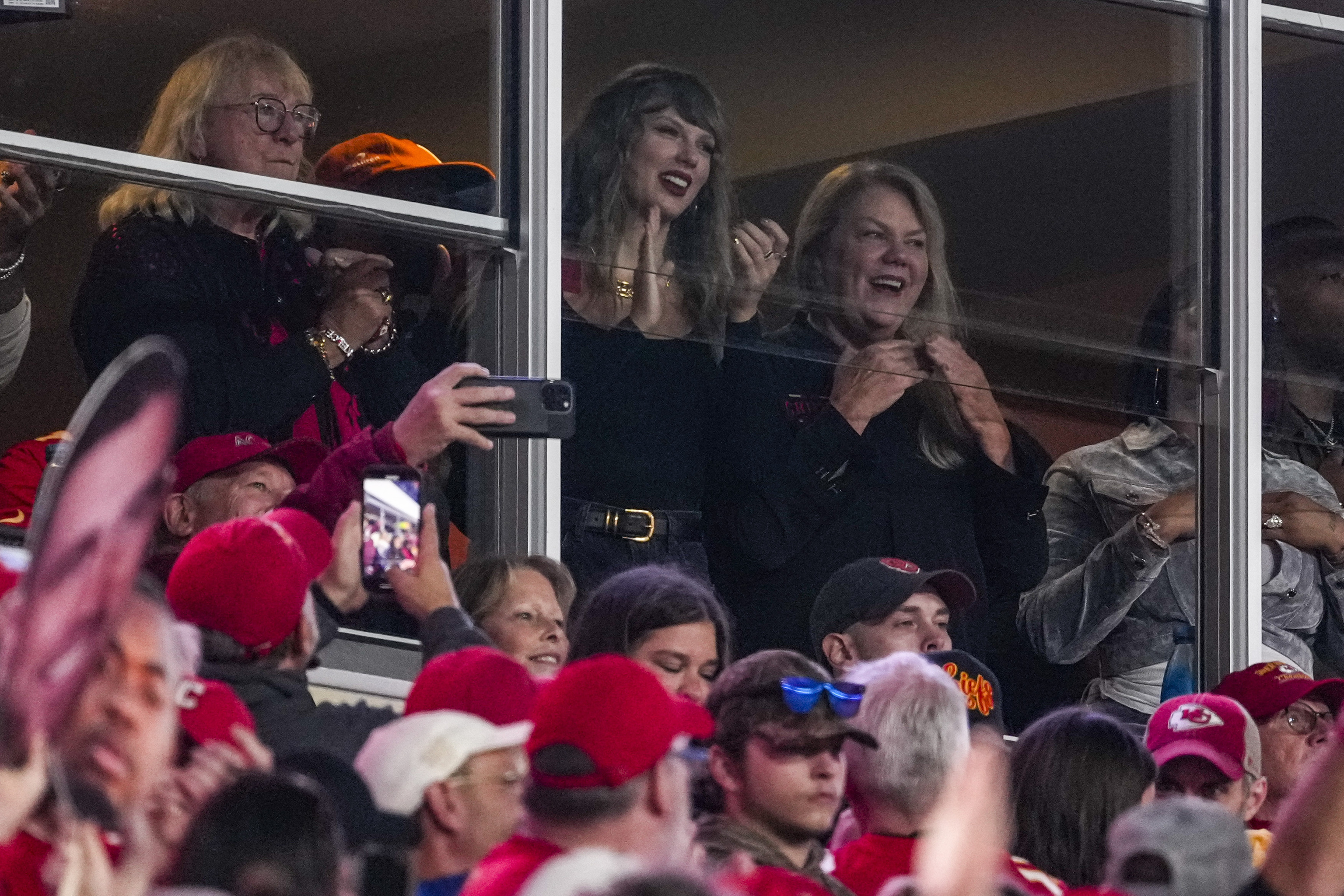 Taylor Swift, top center, watches play during the first half of an NFL football game between the Kansas City Chiefs and the Tampa Bay Buccaneers.