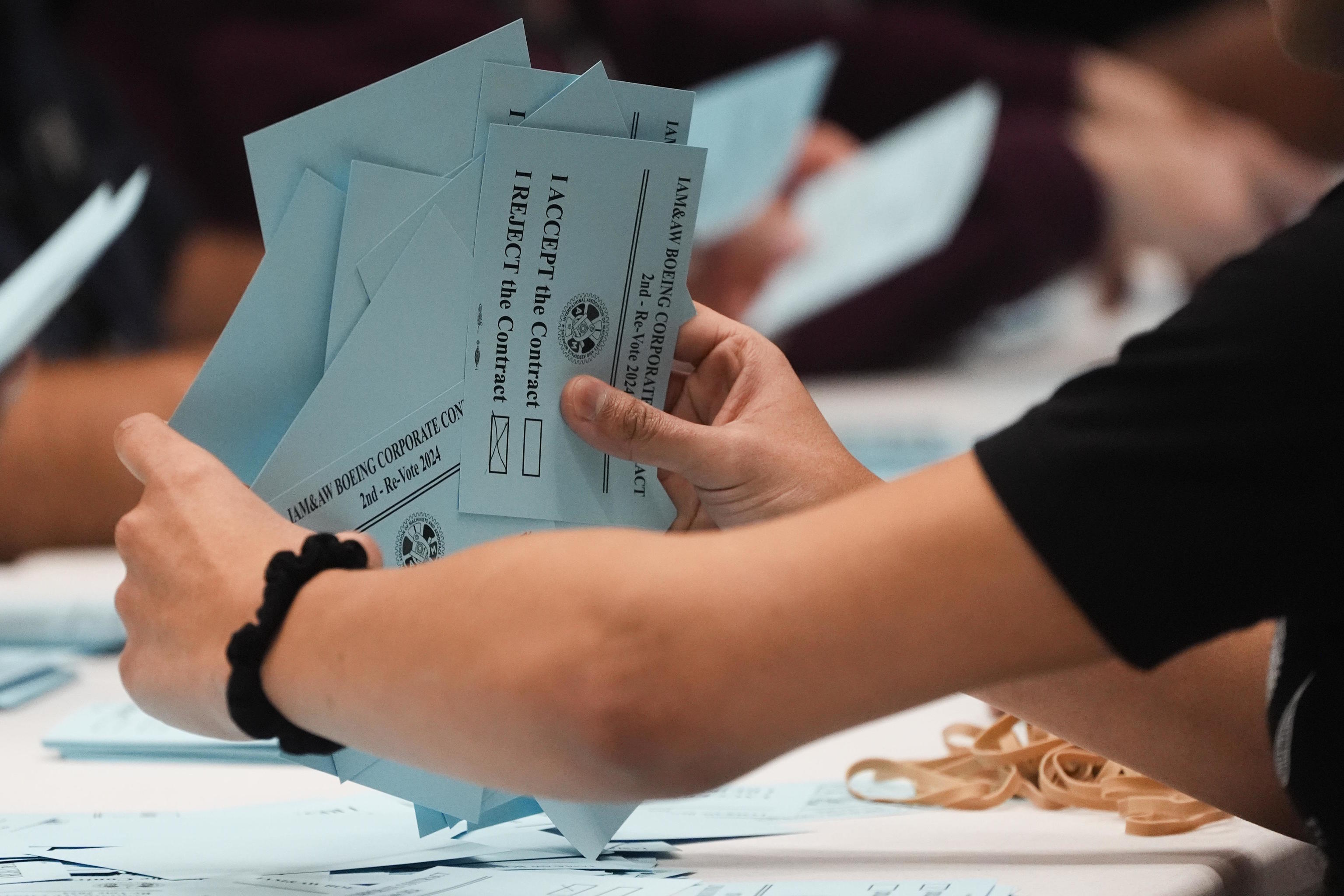 A volunteer sorts votes on a new contract offer from Boeing.