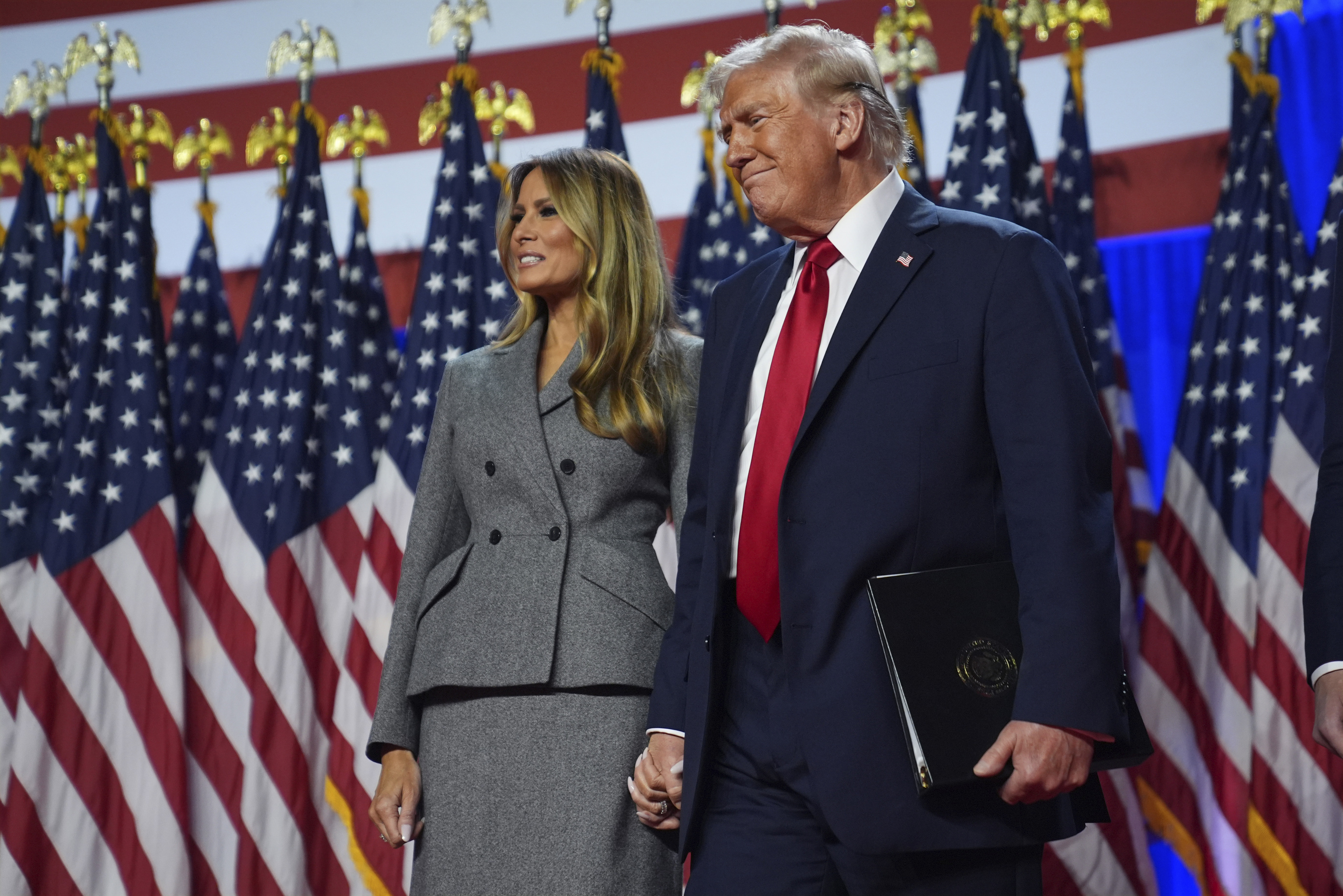 Republican presidential nominee former President Donald Trump stands with former first lady Melania Trump.