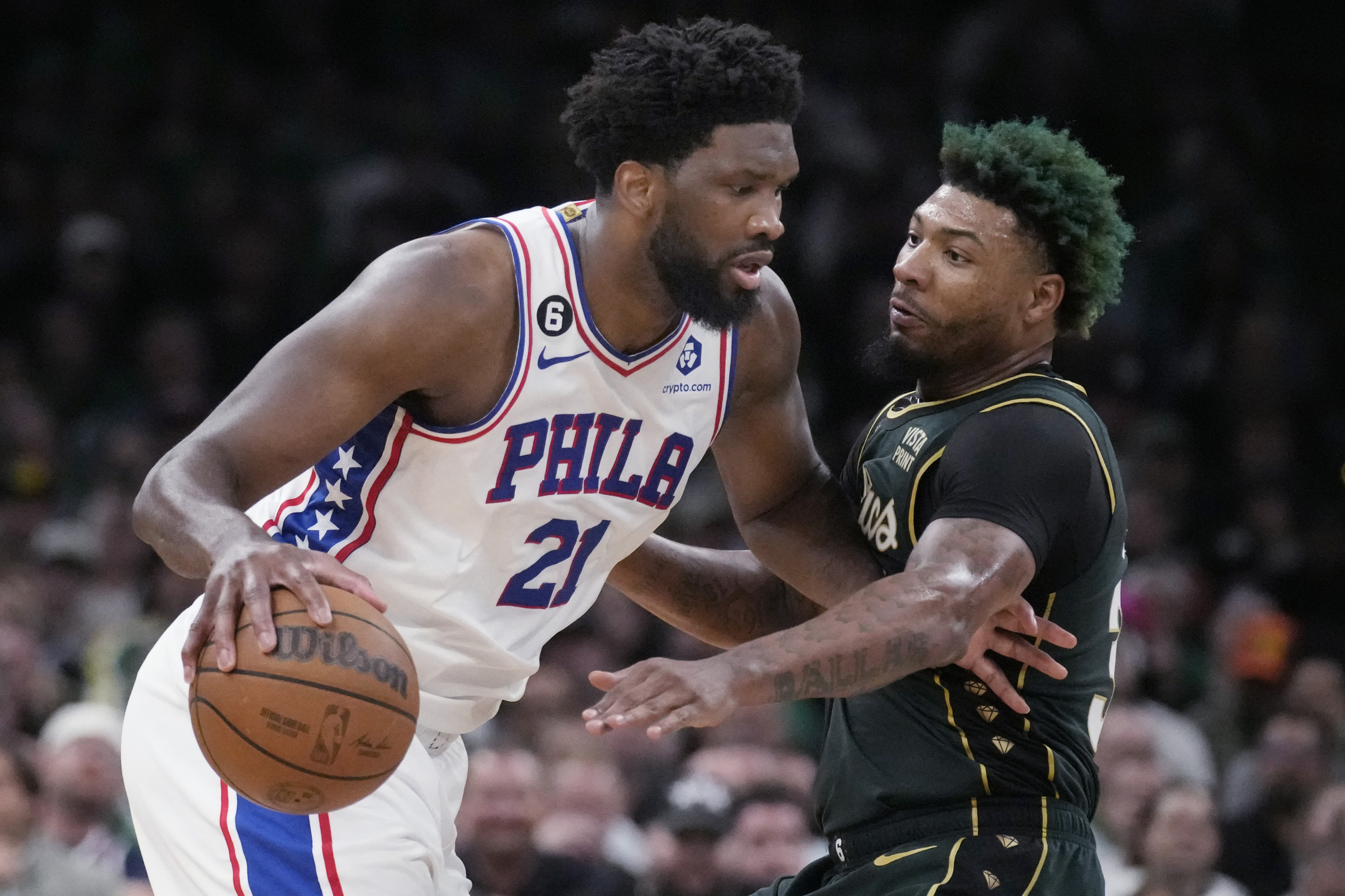 Philadelphia 76ers center Joel Embiid (21) drives to the basket against Boston Celtics guard Marcus Smart.