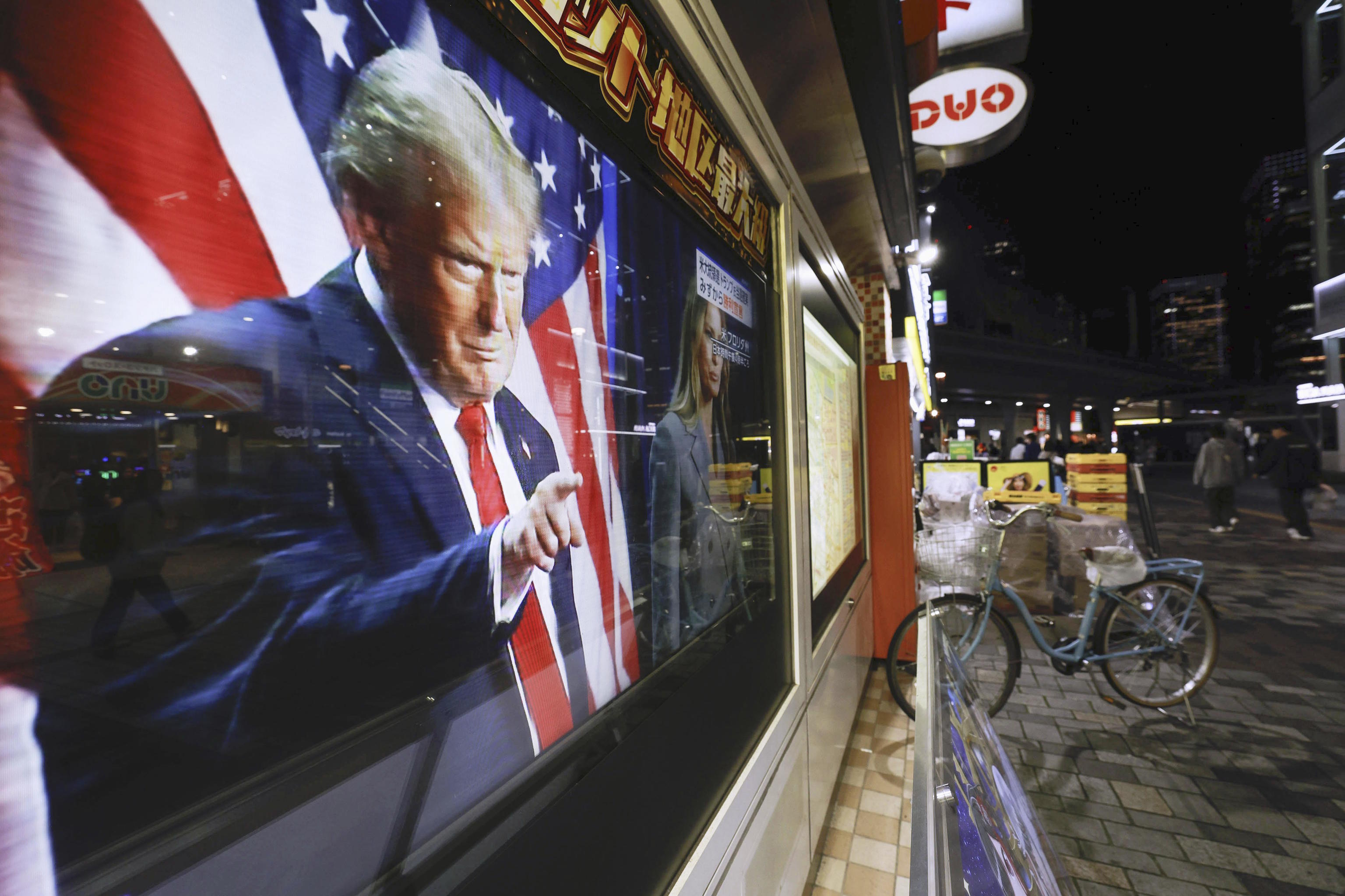 President-elect Donald Trump is seen on a screen during a news program.