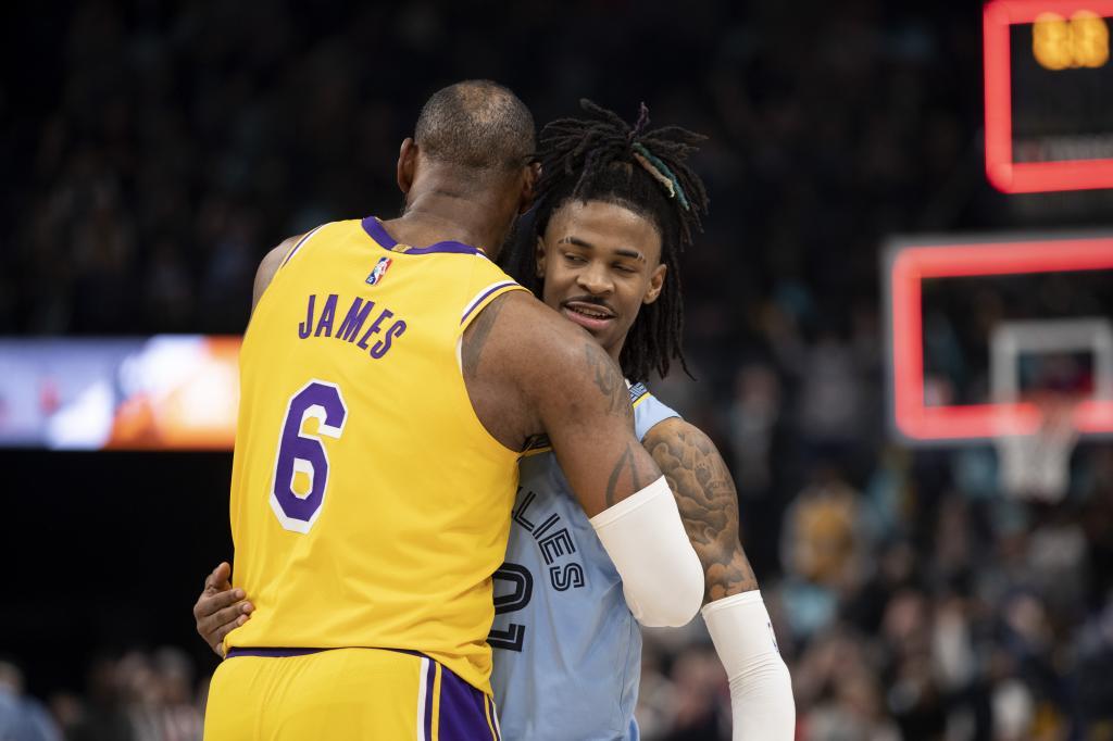 Los Angeles Lakers forward LeBron James (6) embraces Memphis Grizzlies guard Ja Morant (12)