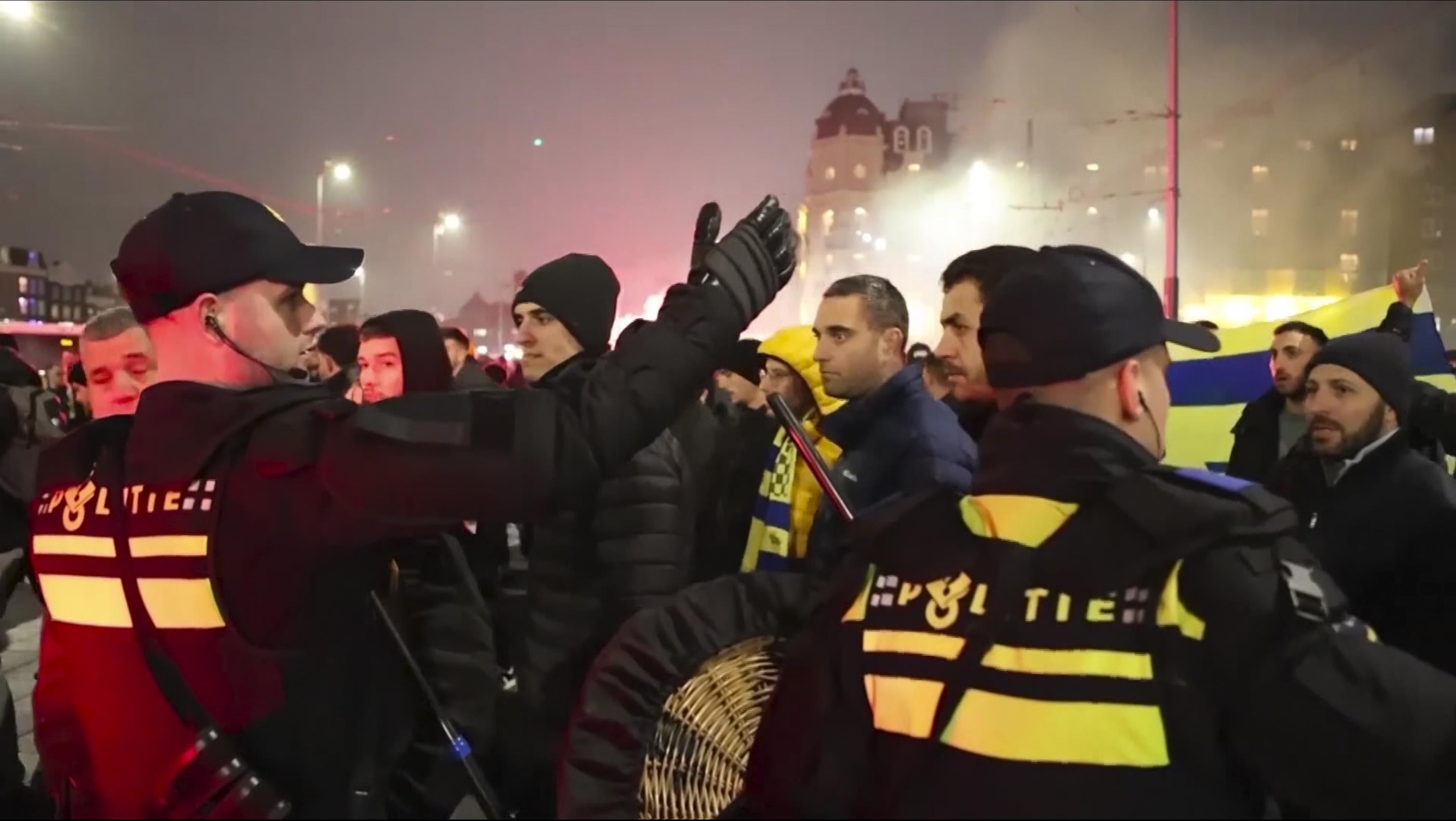 Police escort Maccabi Tel Aviv supporters to the metro station.