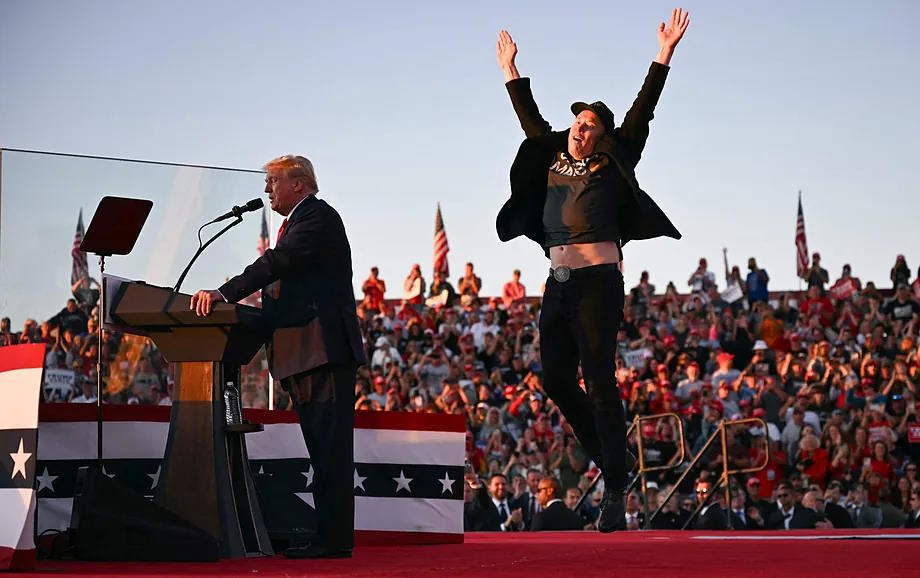 Elon Musk jumps on stage during a rally with Donald Trump last month.