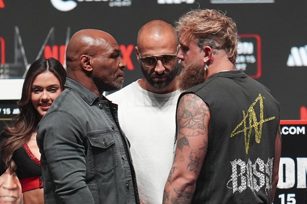 Mike Tyson, left, and Jake Paul, right, meet during the final press conference prior to their fight.