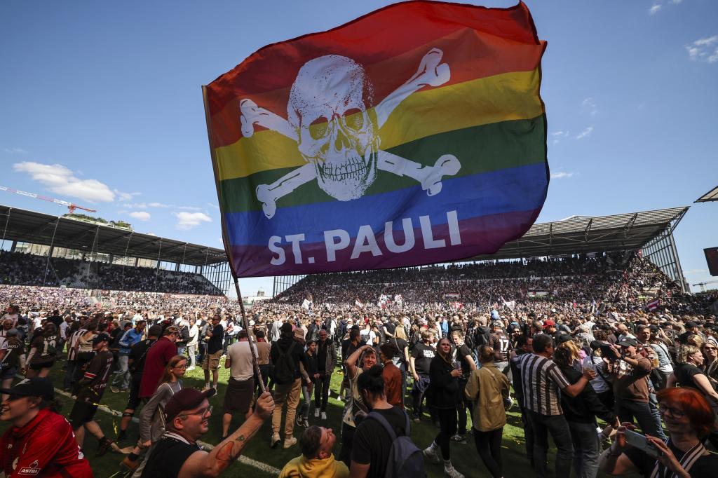 St. Pauli's fans invade the field after their team won 3-1 during a second division