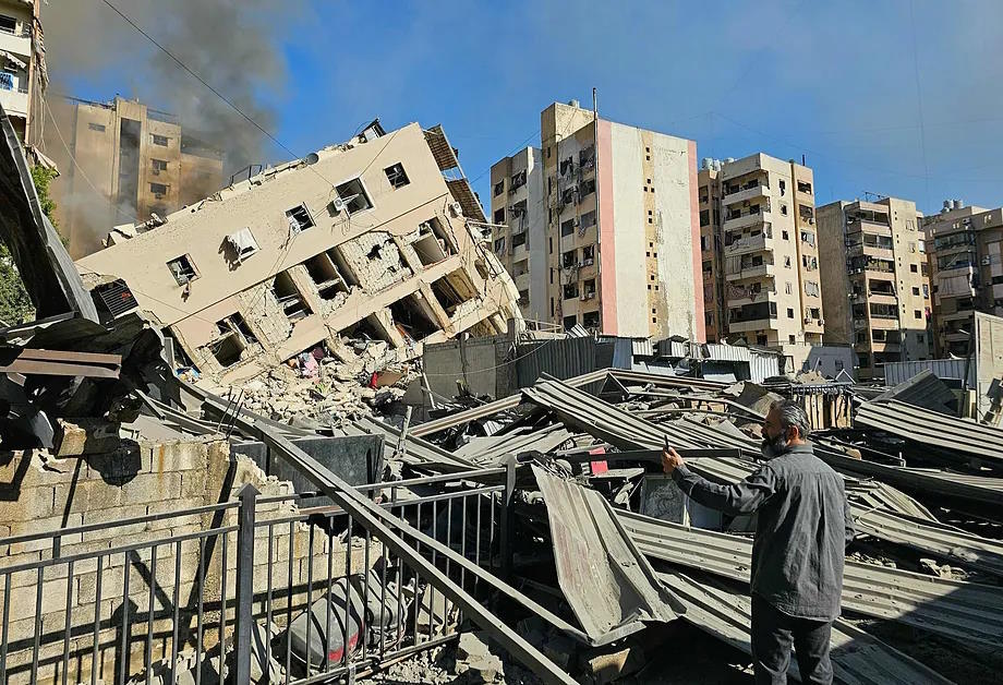 A man observes the ruins of a building in Beirut.