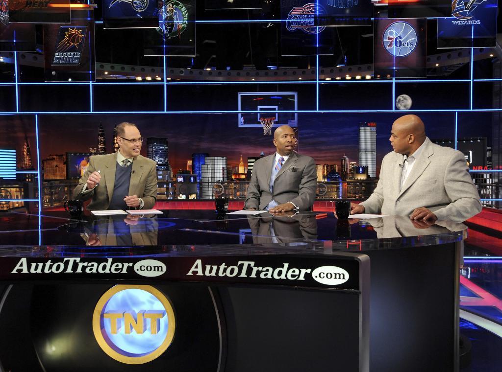 Inside the NBA host Ernie Johnson Jr., left, and analysts Kenny Smith, center, and Charles Barkley speak on the set at the TNT studios in Atlanta