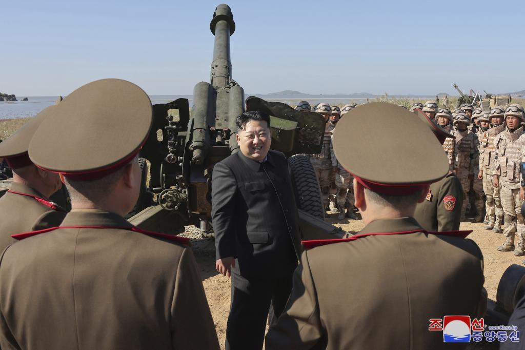 North Korean leader Kim Jong Un, center, visits to watch an artillery exercise at an undisclosed place in North Korea