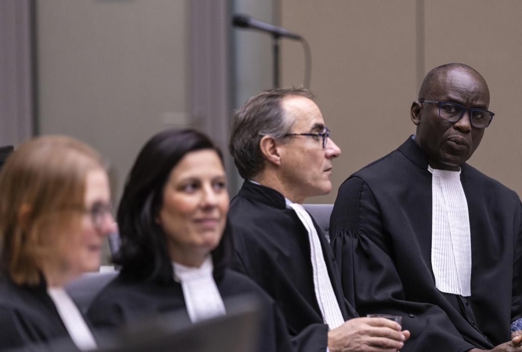 Deputy Prosecutor Gilles Dutertre, second right, and Public Prosecutor Mandiaye Niang, right, look on before the International Criminal Court (ICC) verdict in the Al Hassan case