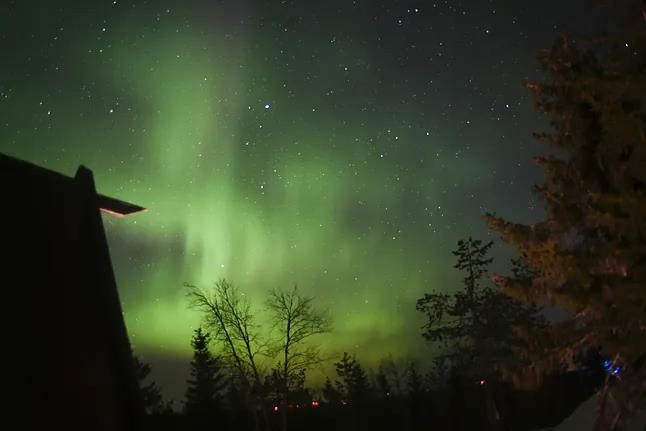 The dance of the Northern Lights as darkness falls in the remote Finnish region of Wild Taiga.