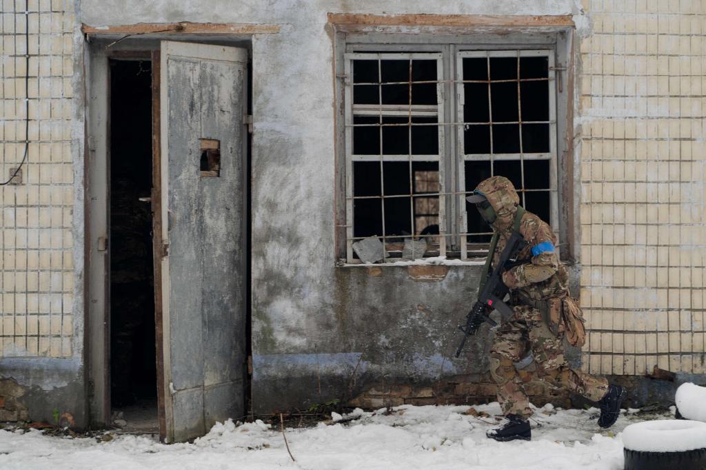 A civilian person wearing military uniform takes part in a military training organized by Ukrainian soldiers