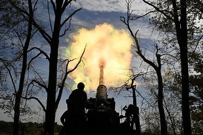 Ukrainian soldiers fire a self-propelled cannon in the Donetsk region.