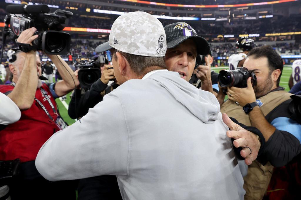 John Harbaugh (R) of the B.Ravens hugs his brother Jim Harbaugh (L) of the LA Chargers.