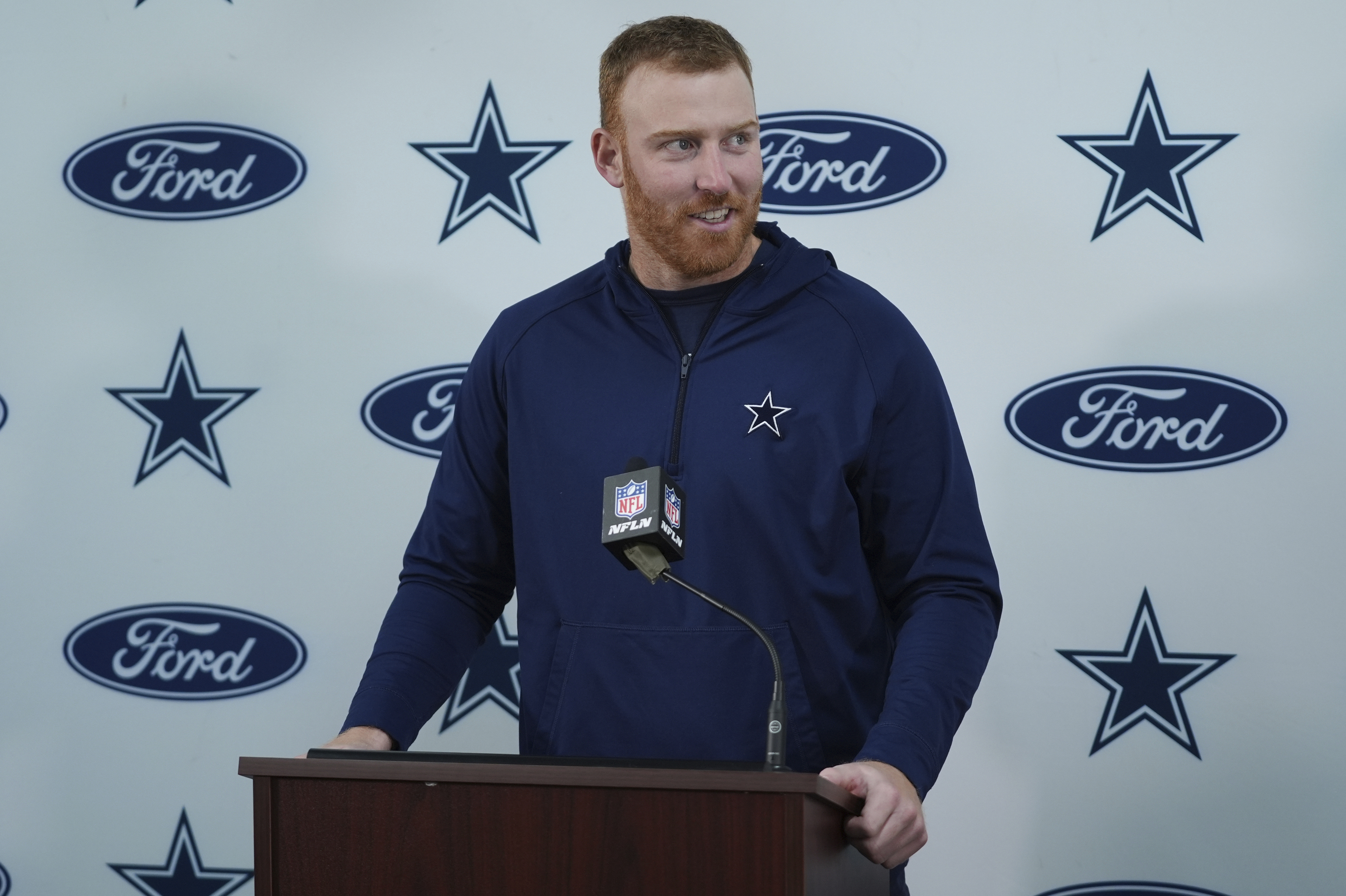 Dallas Cowboys quarterback Cooper Rush answers questions during a press conference.