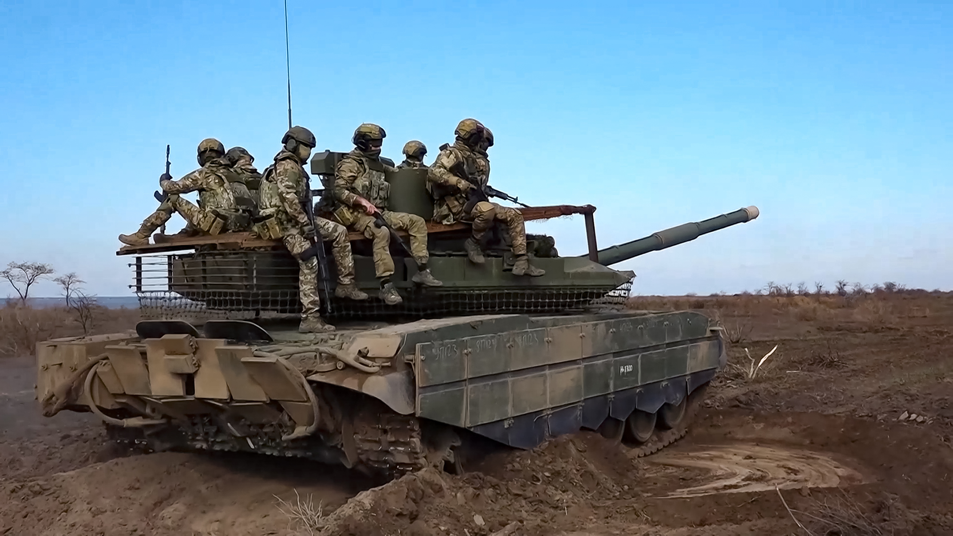 Russian servicemen ride a T-90M Proryv tank during a combat training.