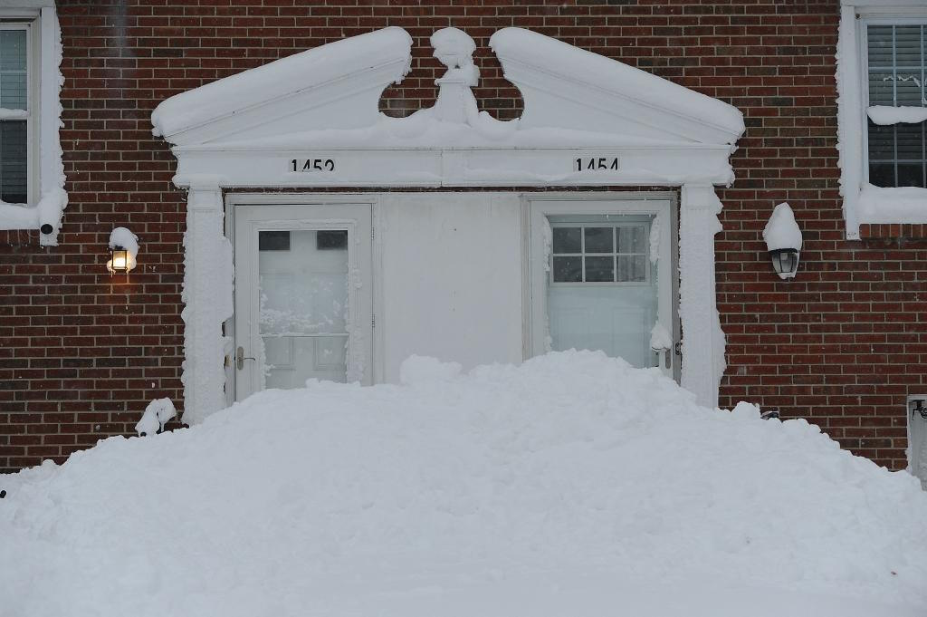 Snow piles up around the entrance doors of homes around Buffalo.