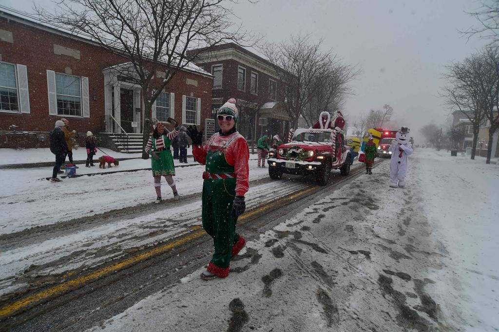 Snow rains down on attendees at the annual Hamburg Holiday Parade in NY.