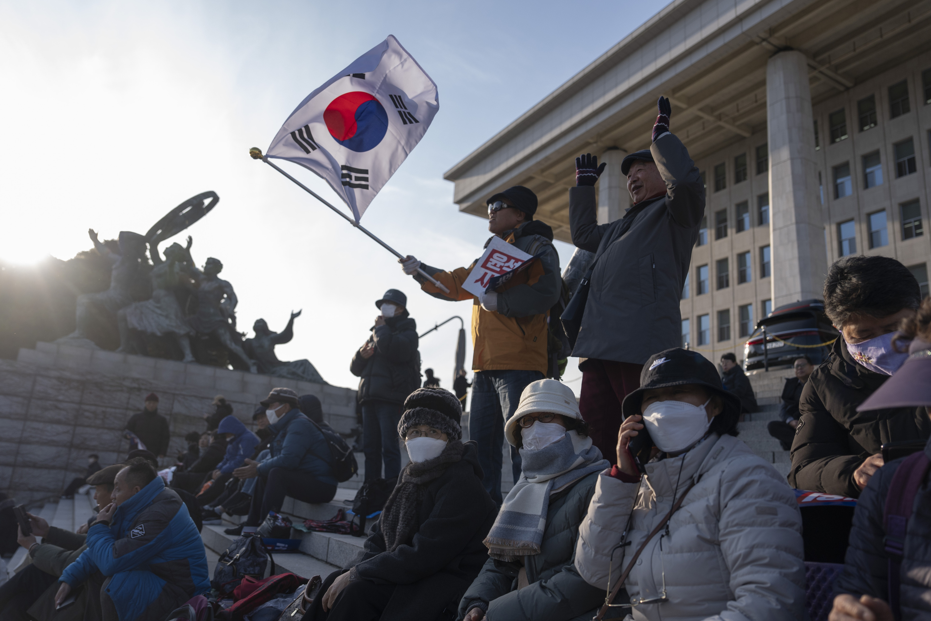 A protester waves a South Korean flag.