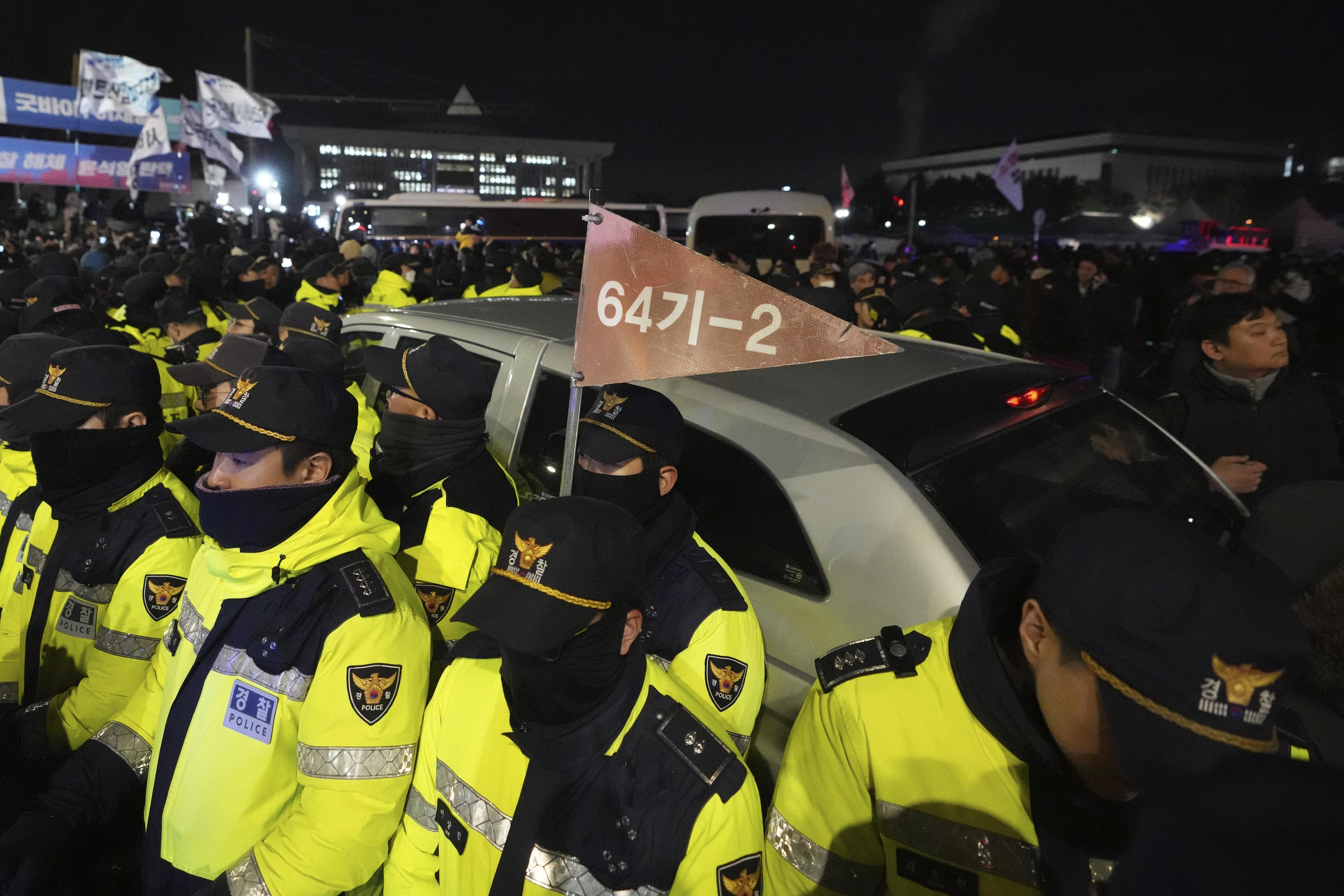 Police officers stand outside the National Assembly in Seoul.