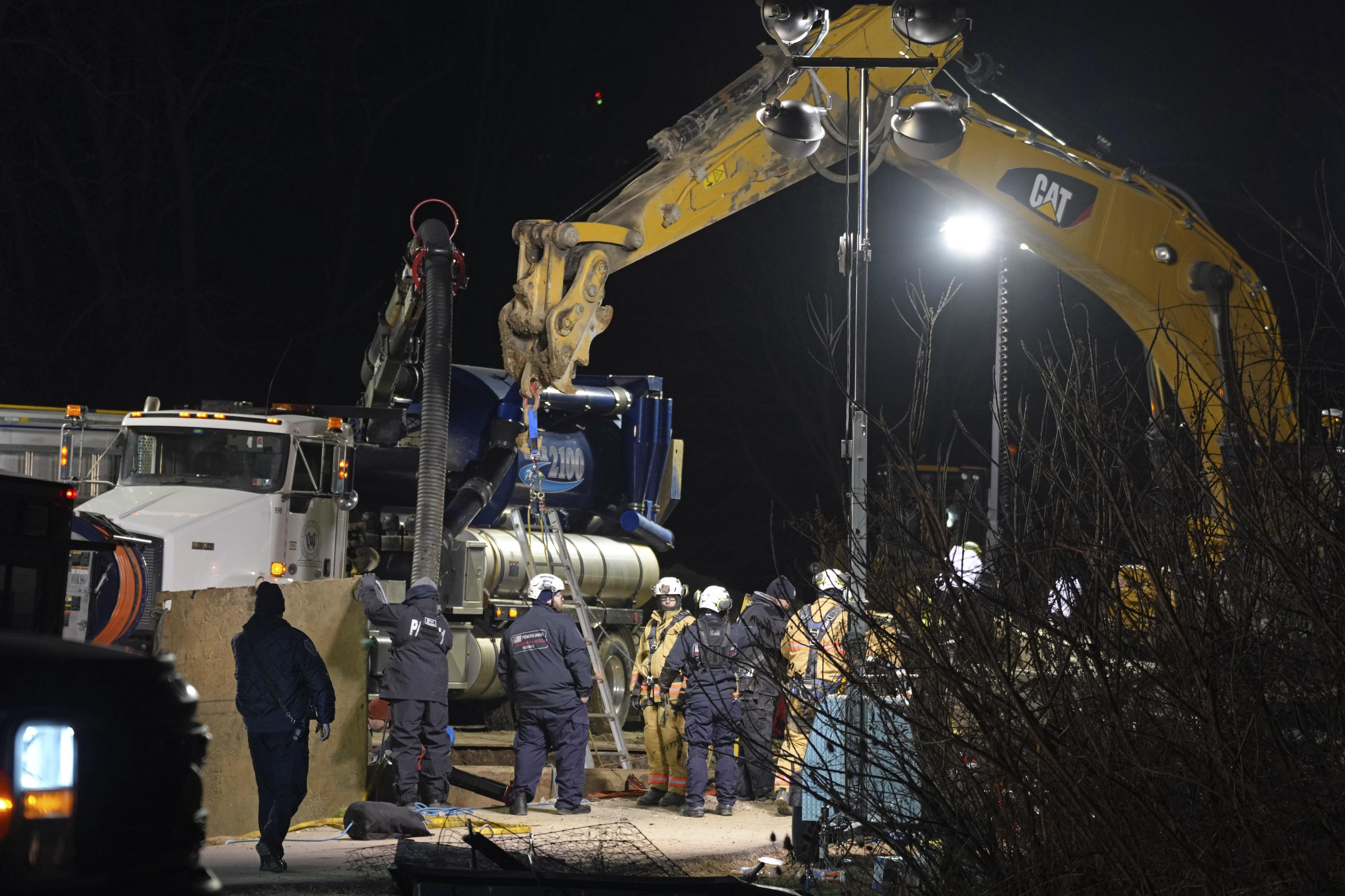 Rescue workers search through the night in a sinkhole for Elizabeth Pollard.