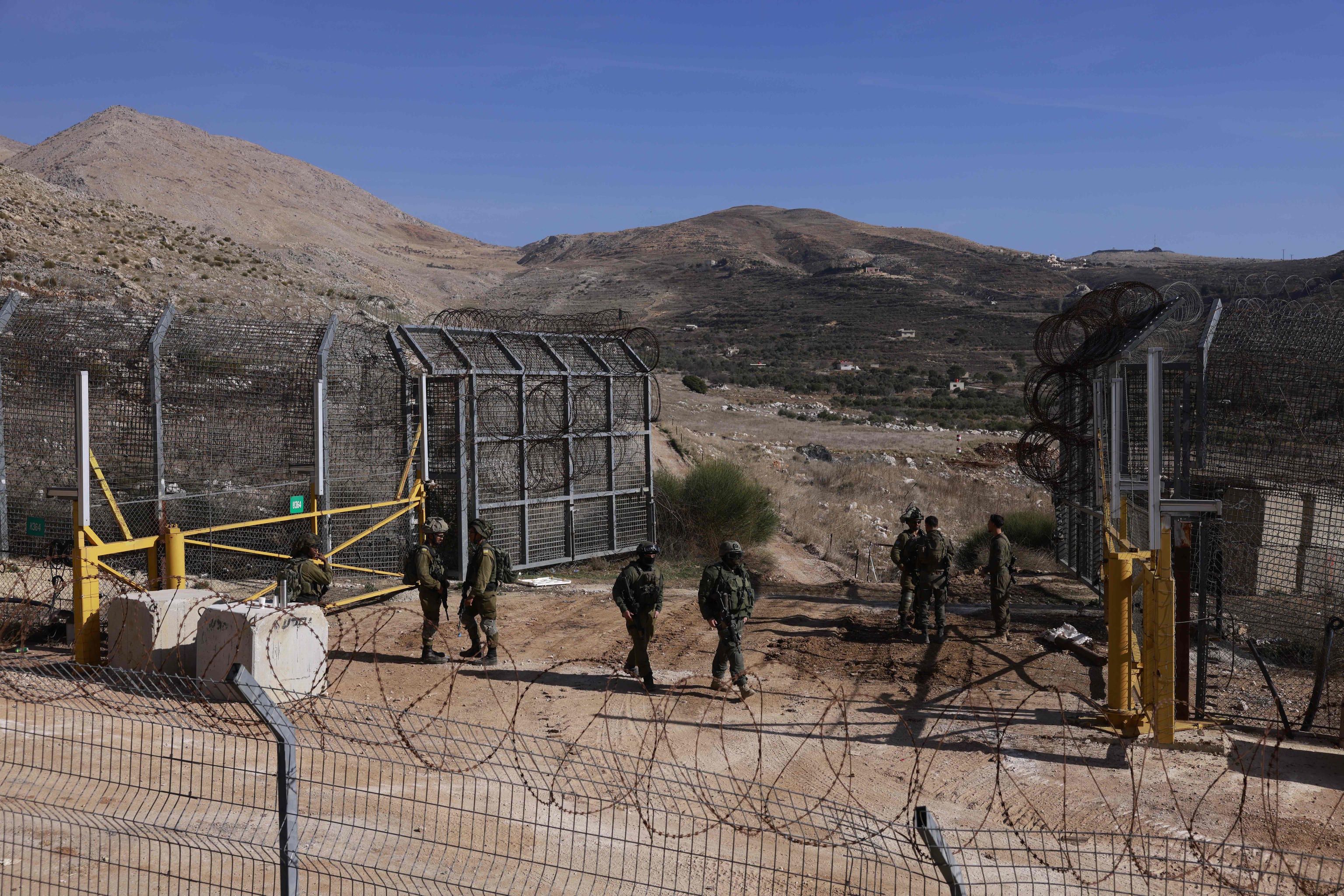 Israeli troops take position on outside the Druze village of Majdal Shams.