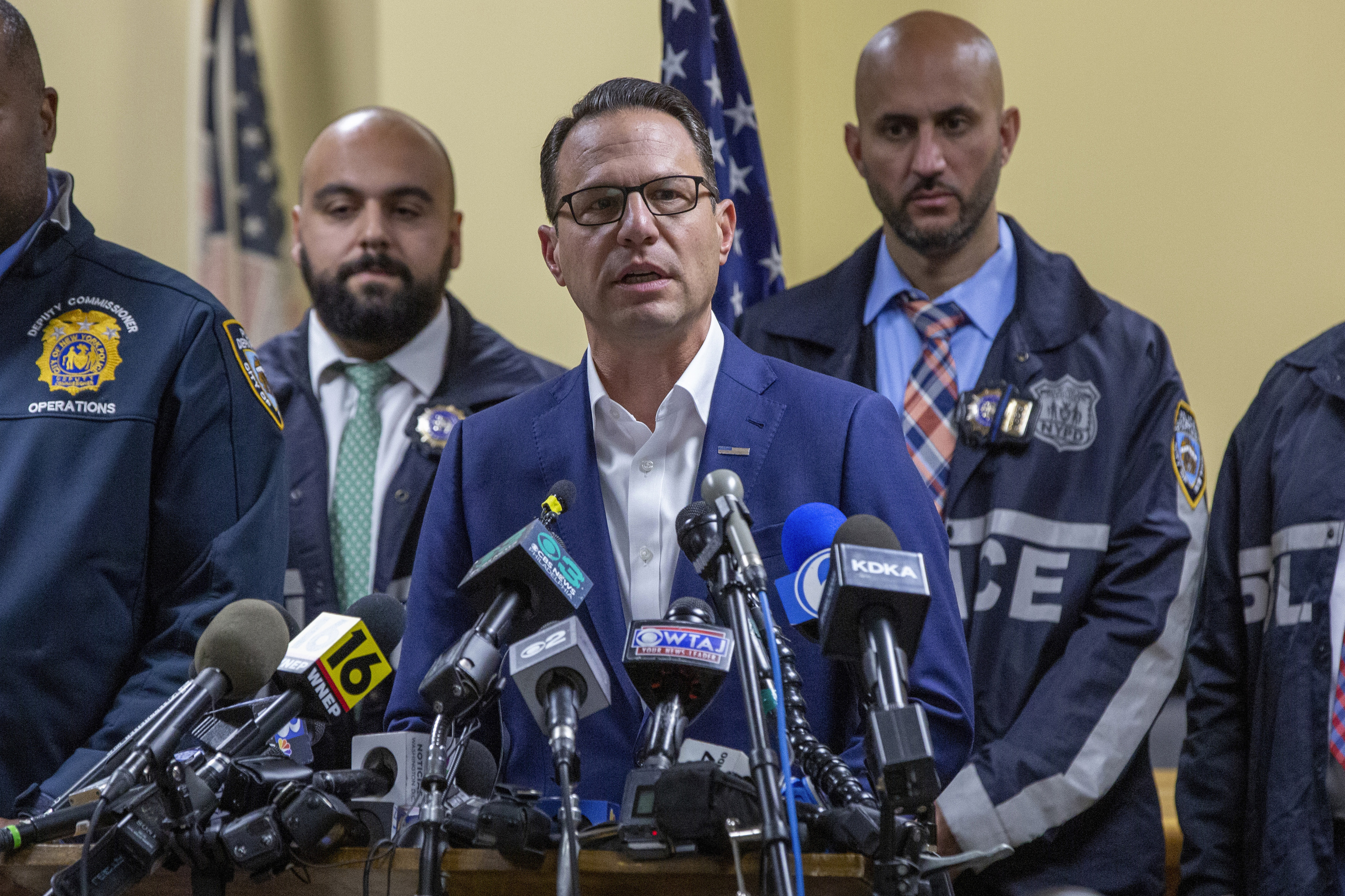 Gov. Josh Shapiro, center, speaks during a press conference regarding the arrest of suspect Luigi Mangione.