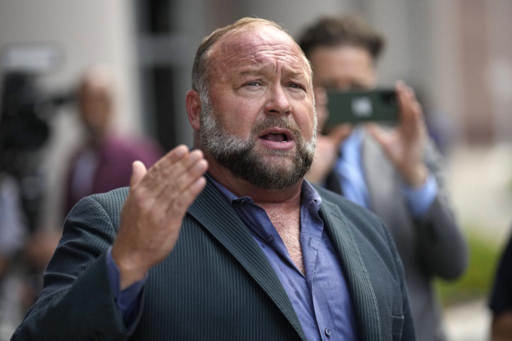 Alex Jones speaks to the media after arriving at the federal courthouse for a hearing in front of a bankruptcy judge