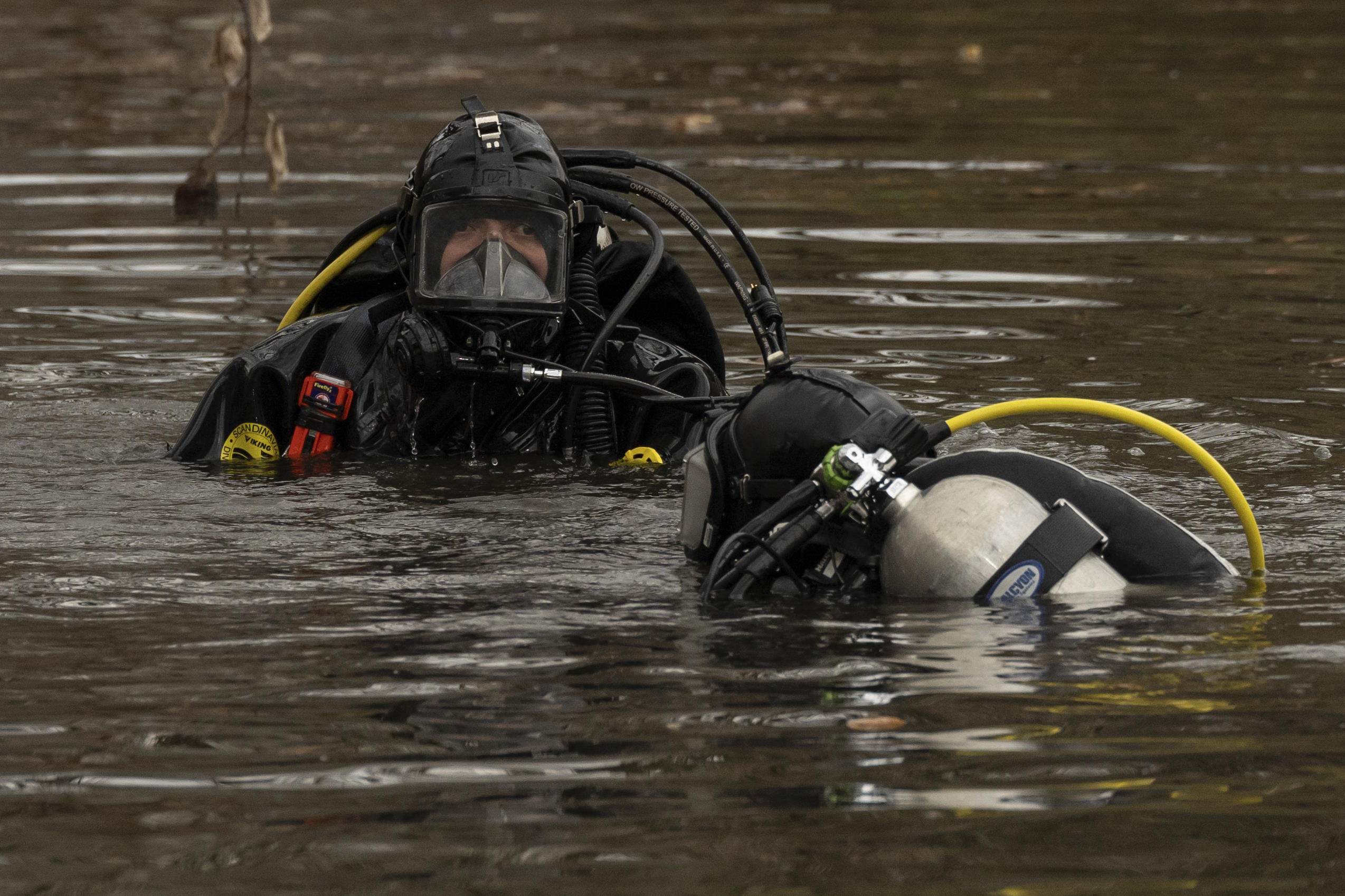 Officers put on diving suits before searching the lake.