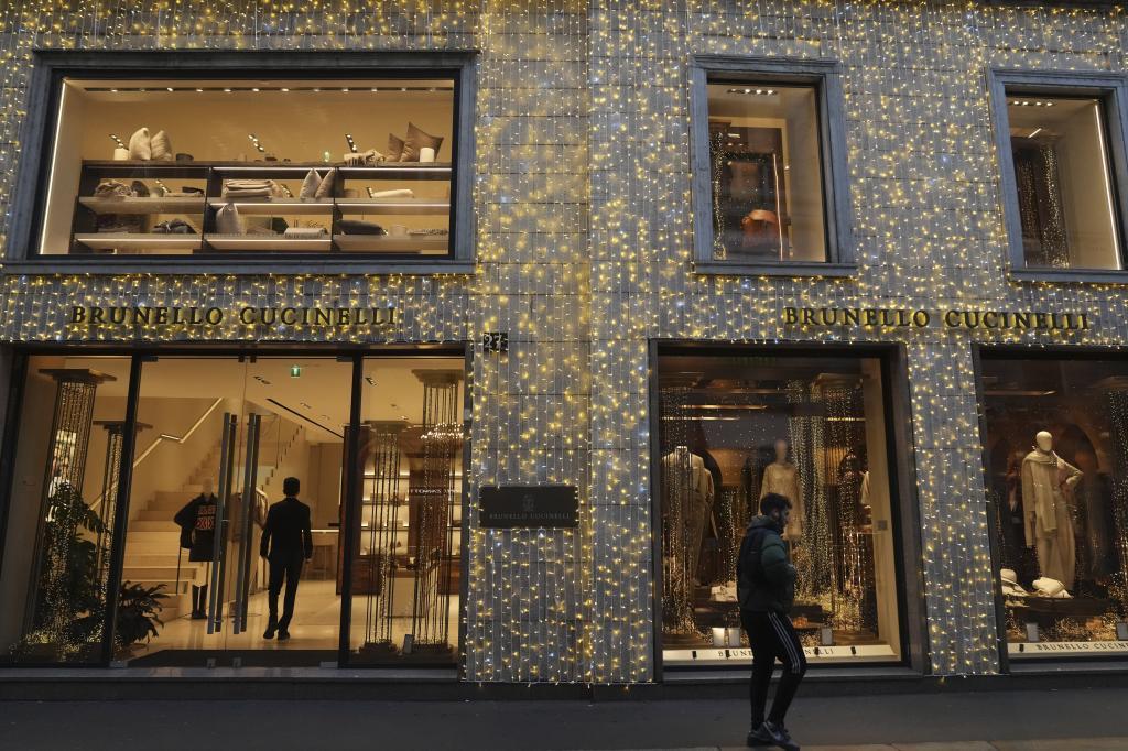 A man walks past a shop in Monte Napoleone street in Milan