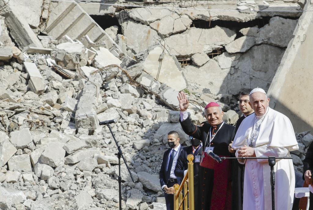 Mosul and Aqra Archbishop Najib Mikhael Moussa, left, waves as he stands next to Pope Francis