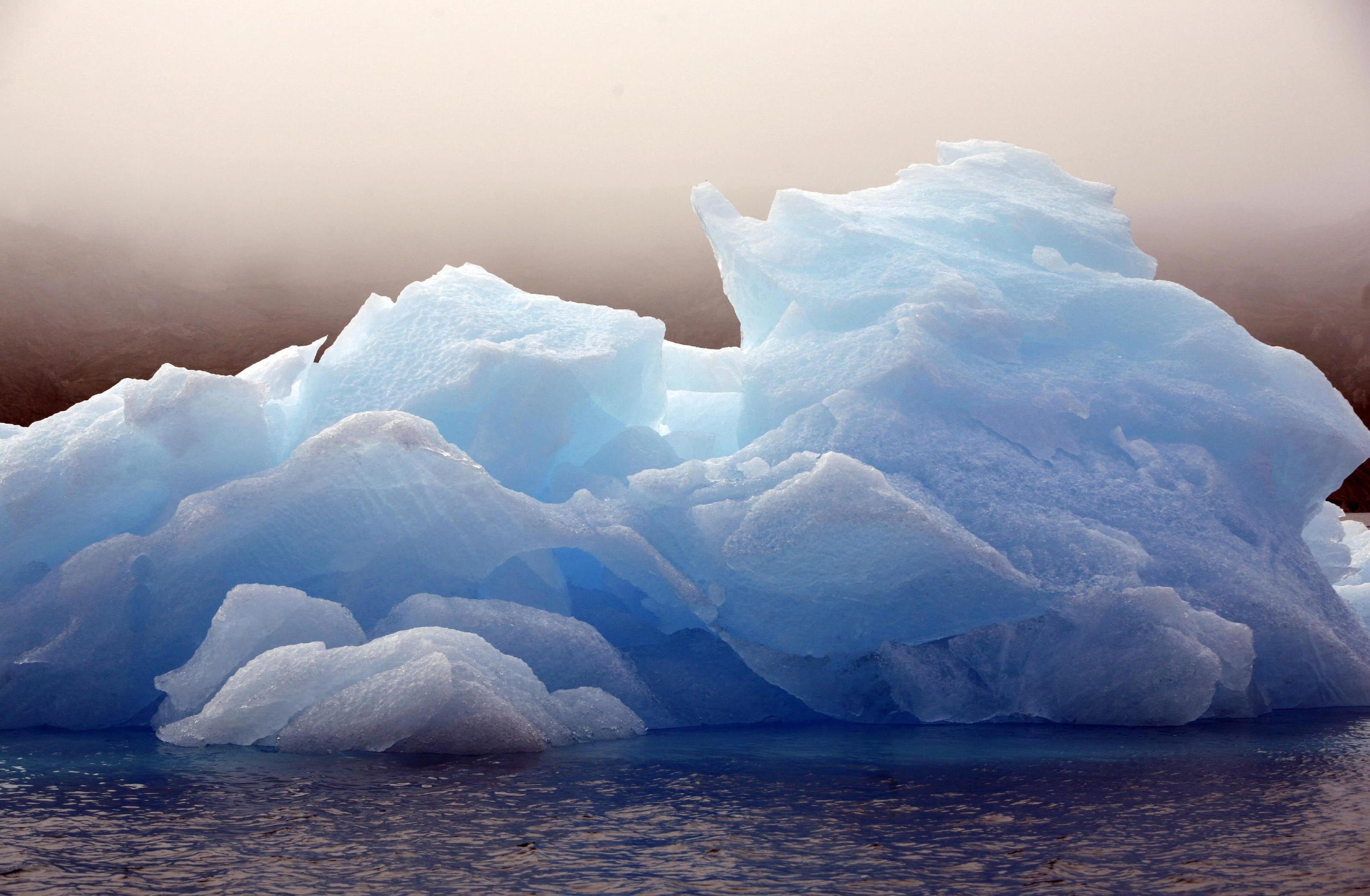 An iceberg floats in a bay.