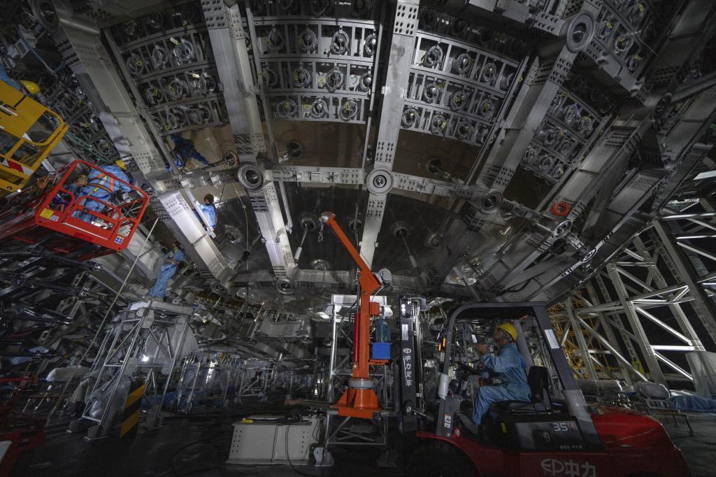 Workers labor on the underside of the cosmic detector located 2297 feet (700 meters) underground