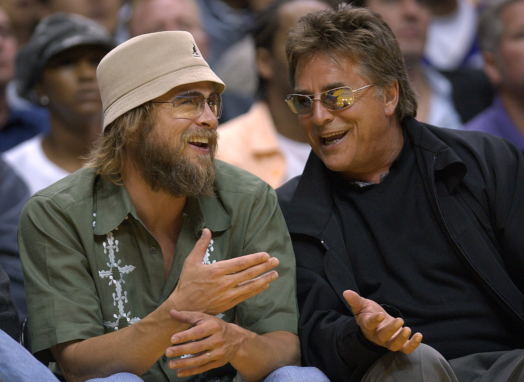 Brad Pitt and Don Johnson talk during a game.