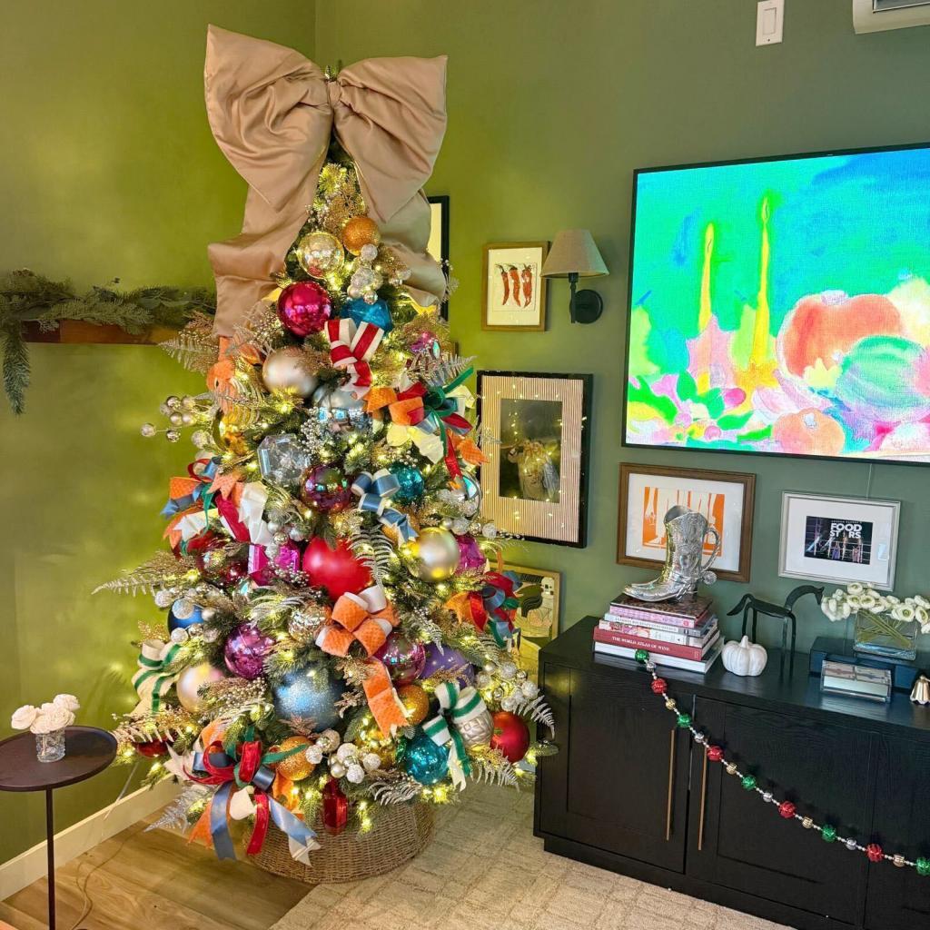 A skinny artificial tree bought at Target that Druey decorated with retro big holiday ornament balls in primary colors in reds and blues