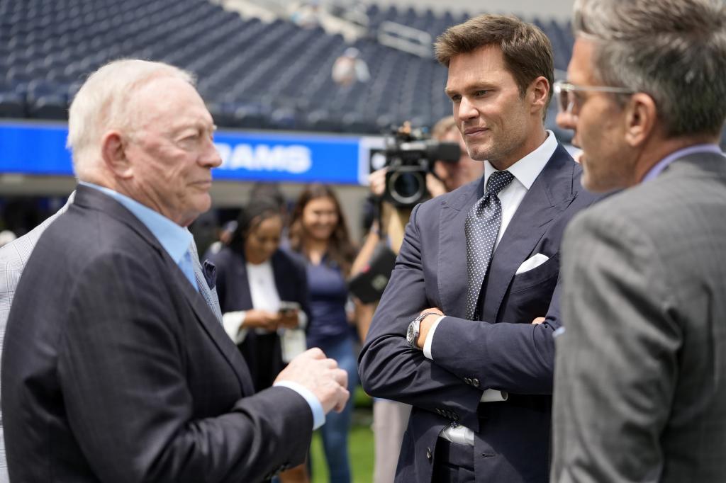 Tom Brady, center, talks with Dallas Cowboys team owner Jerry Jones