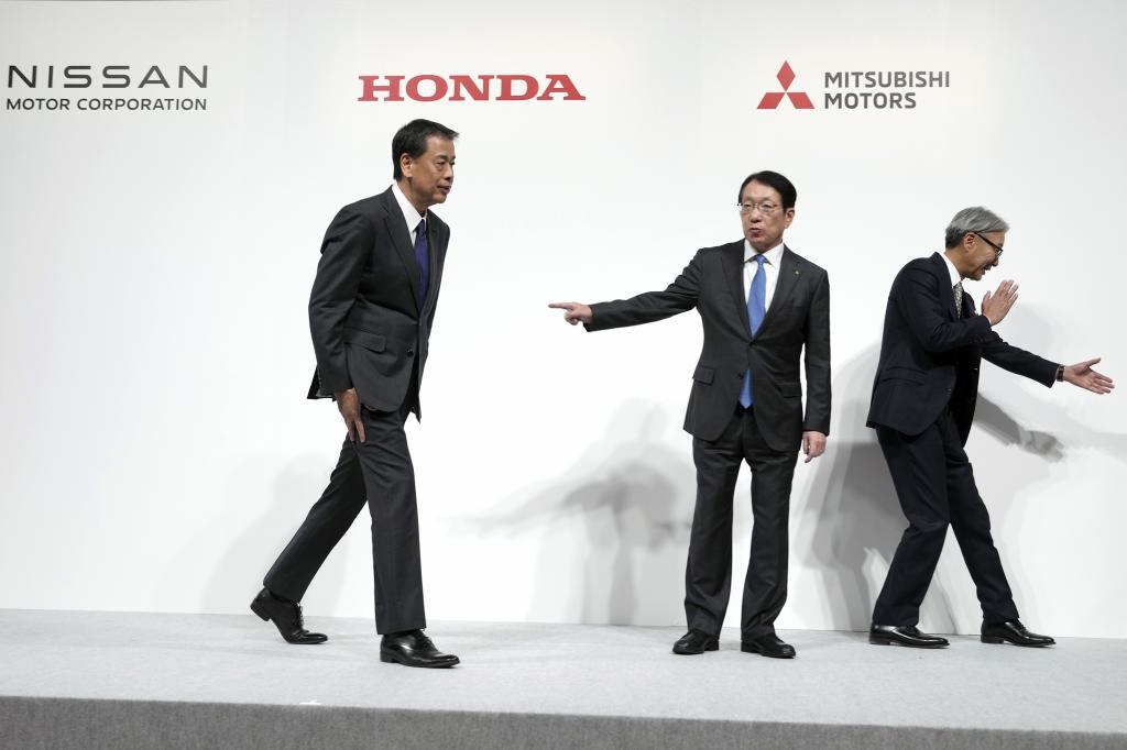 Nissan Chief Executive Makoto Uchida, left, Takao Kato, CEO of Mitsubishi Motors, center, and Honda Chief Executive Toshihiro Mibe, right,