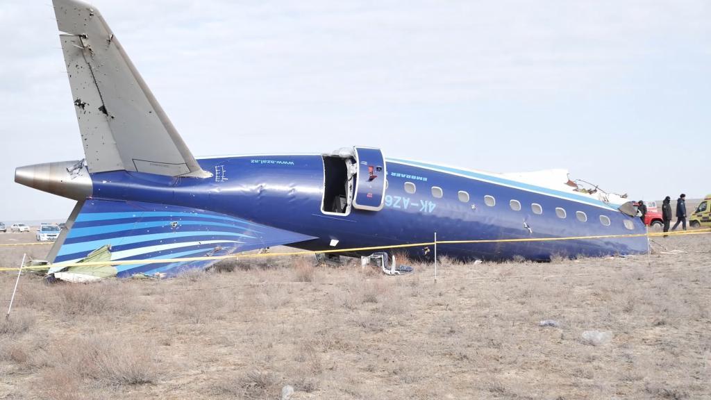 A part of Azerbaijan Airlines' Embraer 190 lies on the ground near the airport of Aktau