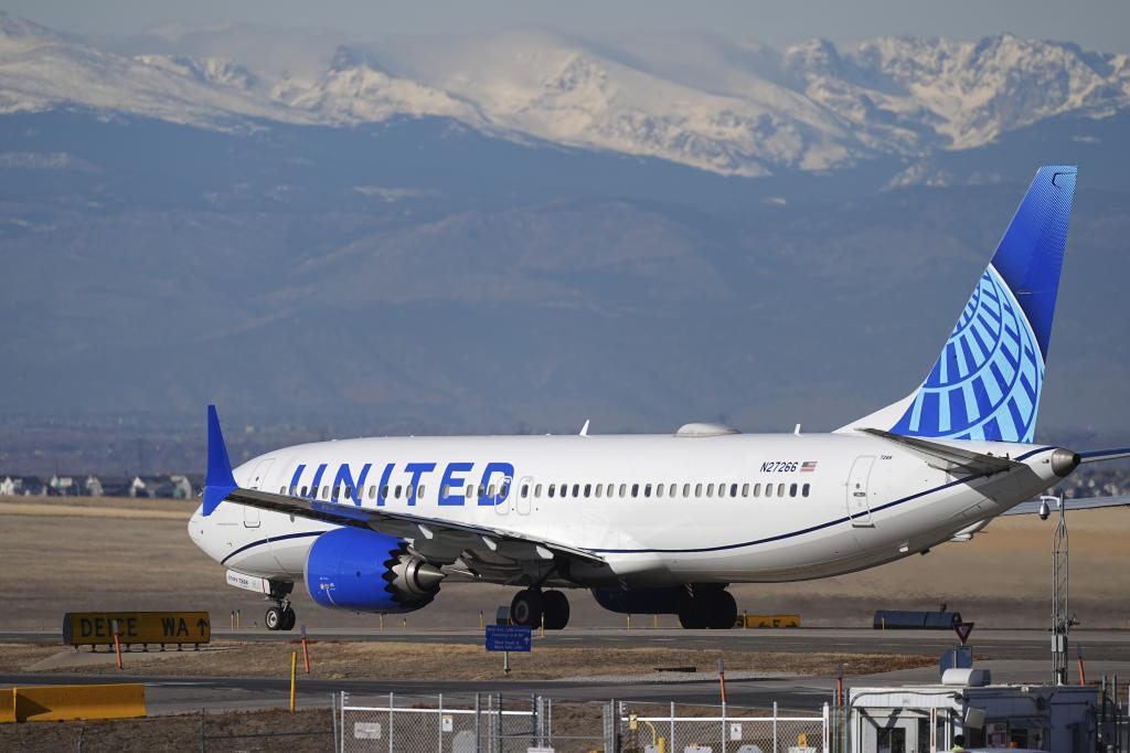 A United Airlines jetliner taxis down a runway for take off at Denver International Airport