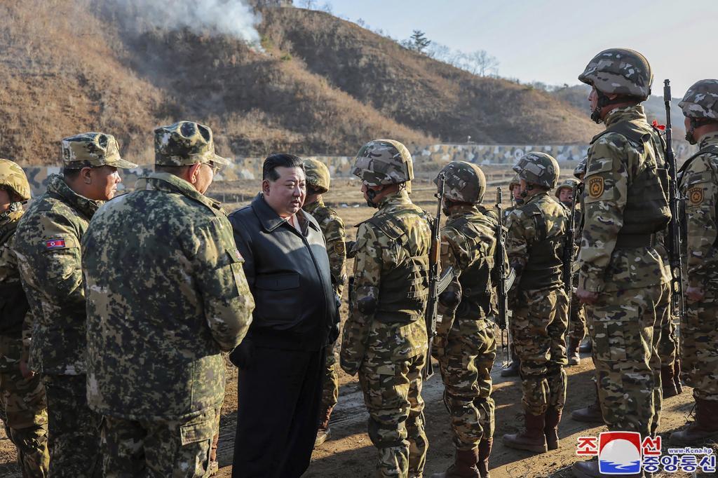 North Korean leader Kim Jong Un, center left, meets soldiers